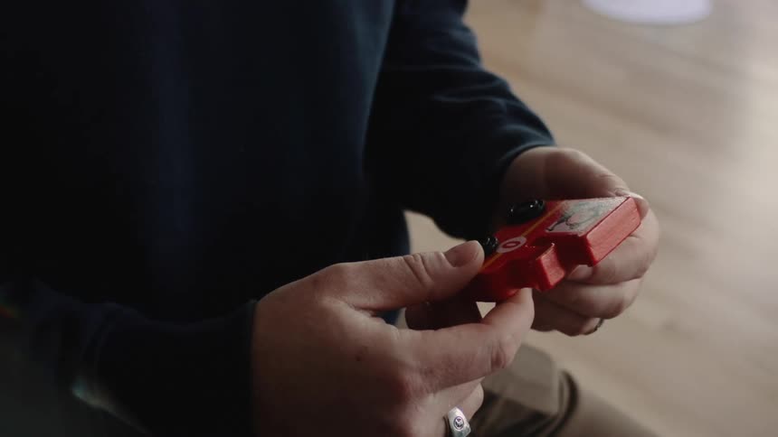 A person is holding a toy car
