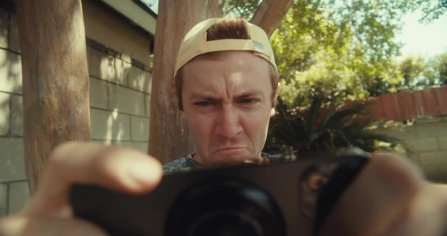 A man looks in confusion at his phone