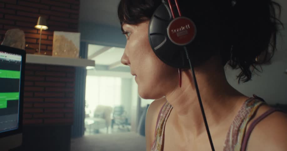 A woman is using a soundboard to make music