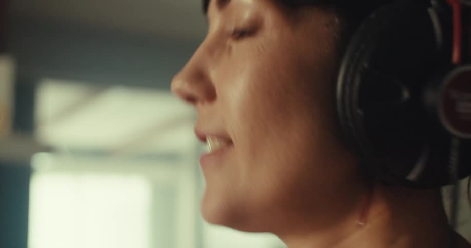 A woman presses buttons on the soundboard to create music