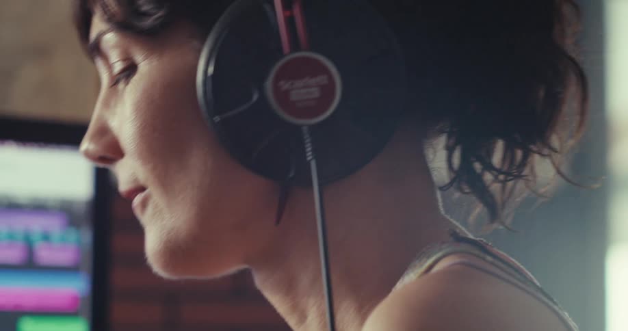 A woman is using a soundboard to make music