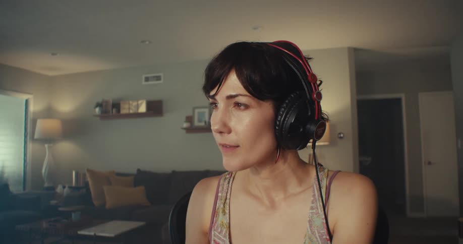 A woman nods her head as she listens to music
