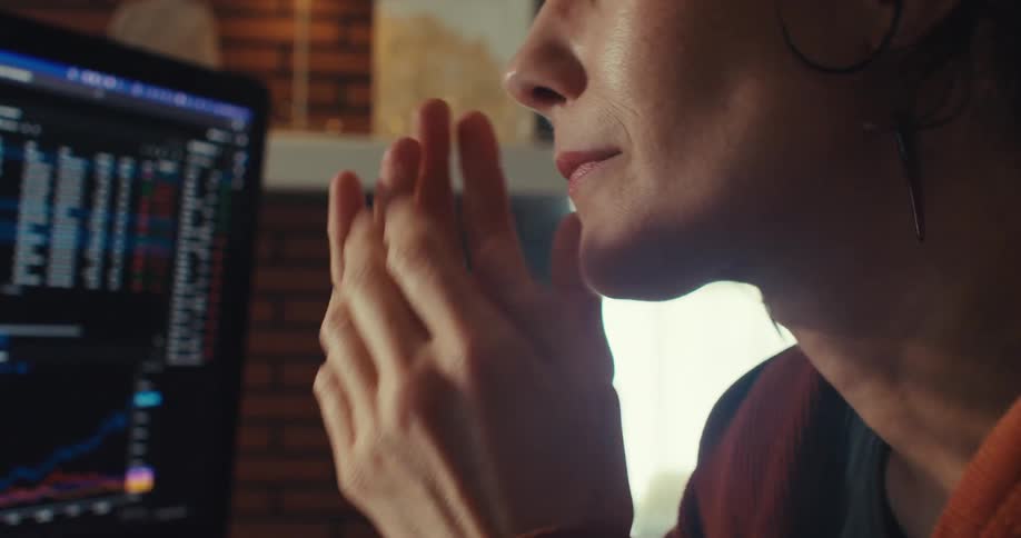 A woman is upset and starts to cry as she sits in front of a computer