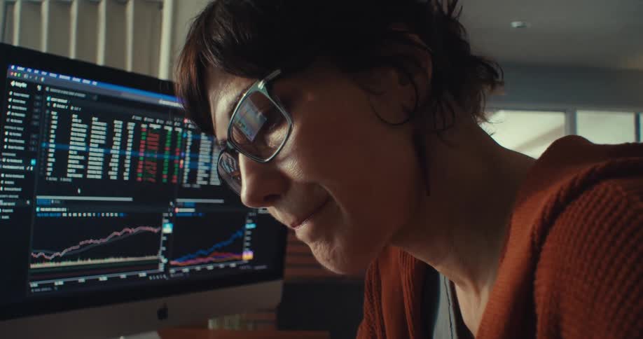 A woman sitting at a table tense and worried shaking her head no