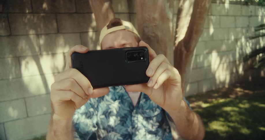 A man tracks someone behind the camera with his phone