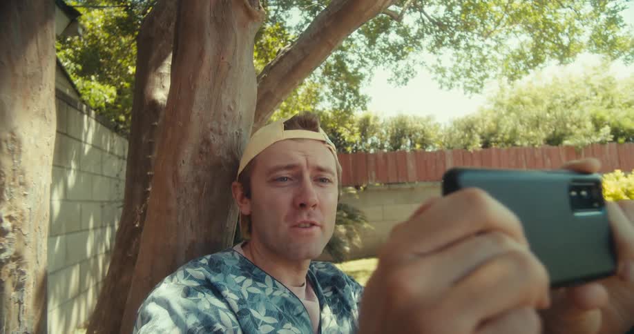A man takes a panoramic shot with his phone