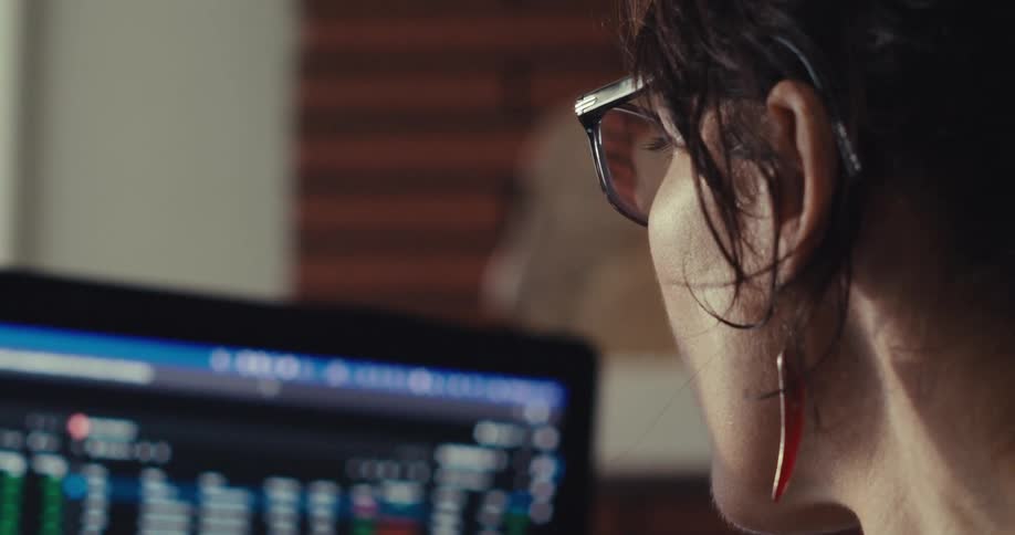 A woman touches the monitor full of information