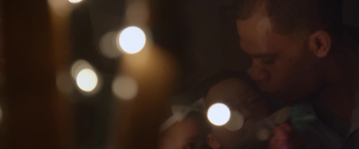 White lights shine as a dad talks with children