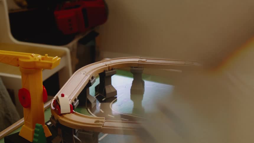 A series of childrens play toys arranged to depict a toy city with roads