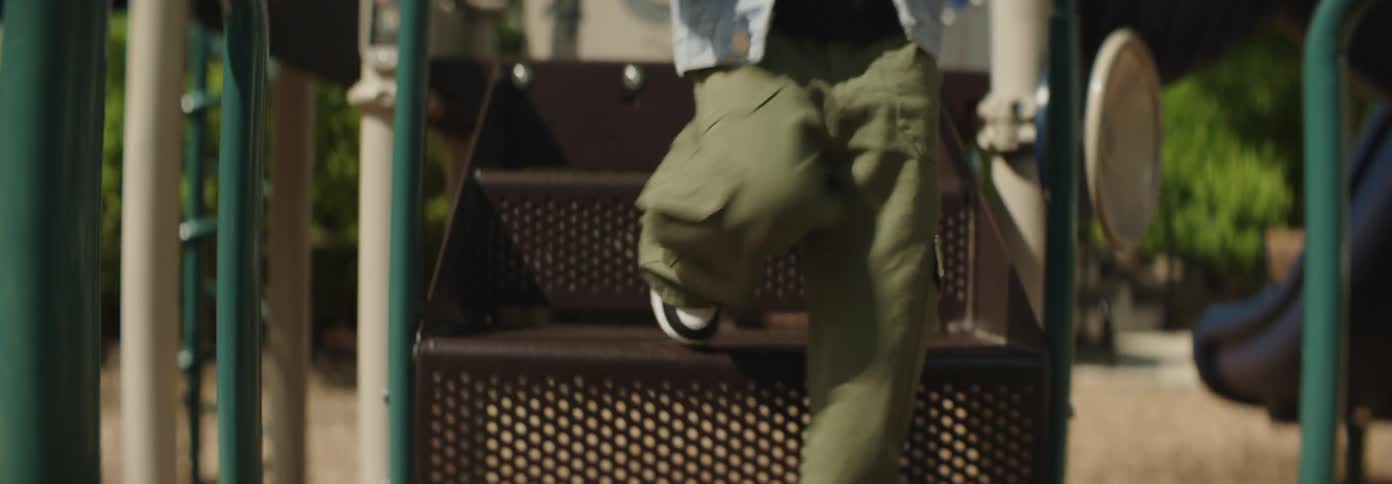 A child climbs down the stairs in the playground