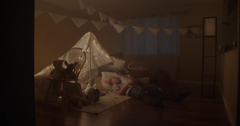 A small tent is set in a dark room
