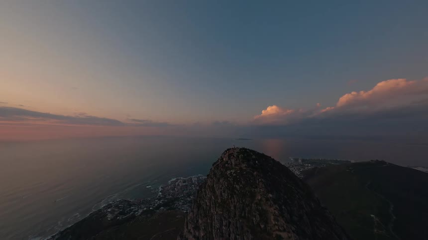 Flying over a rocky outcropping by the sea