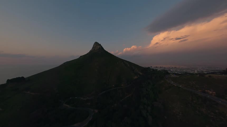 A mountain is shown with a city in the distance