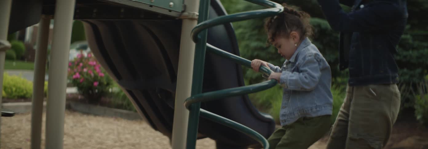 A mother and daughter are playing on the playground