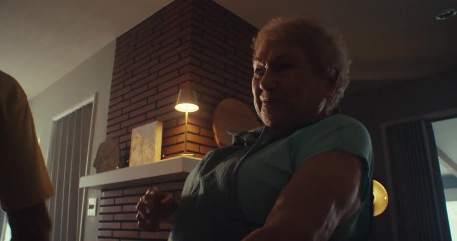 Elderly couple dancing and laughing in their living room having fun