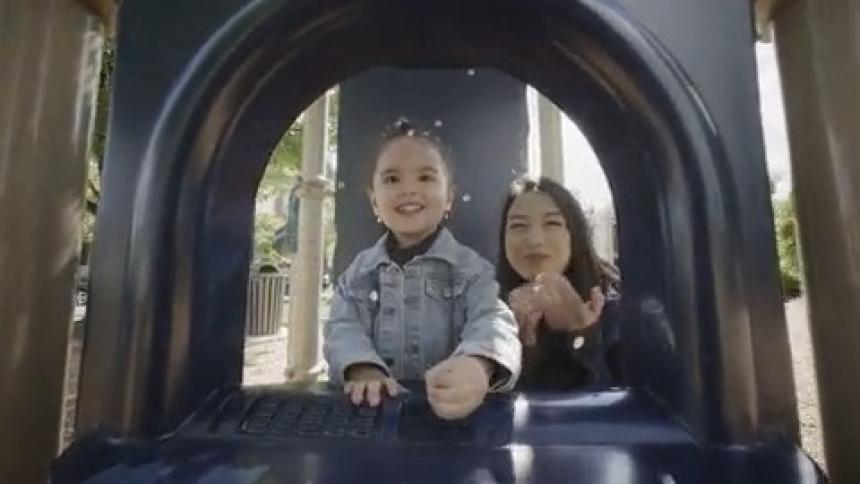 A woman and a child playing in a playground