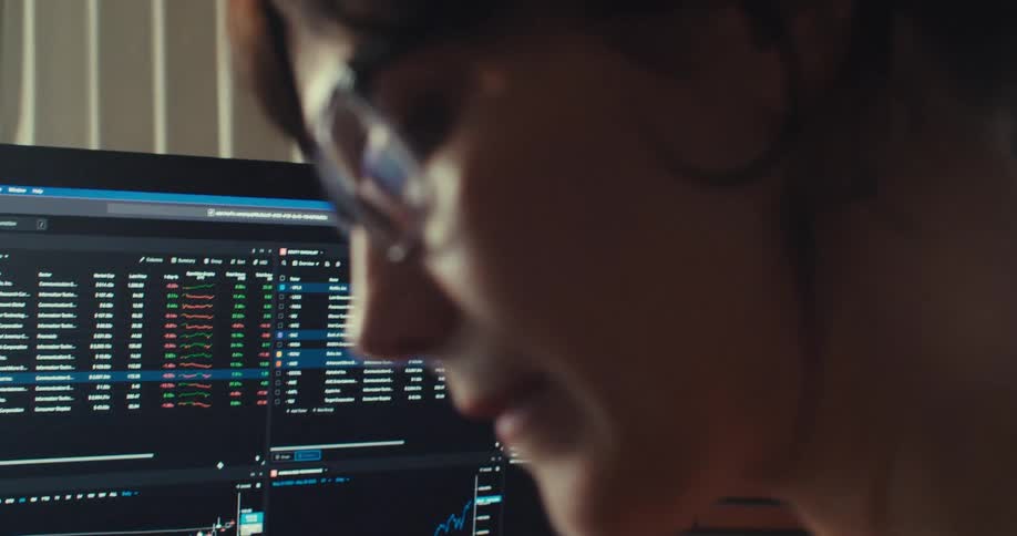 A woman is at her desk working on the computer