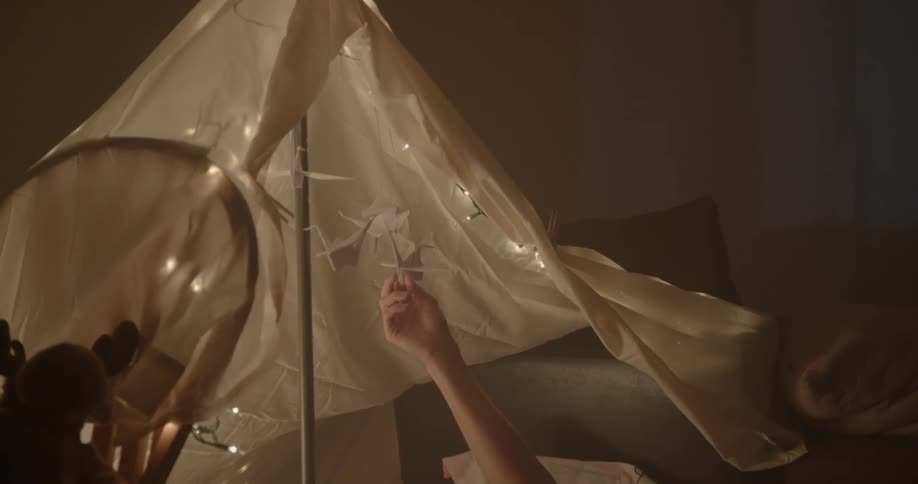 A small tent is in a dark room