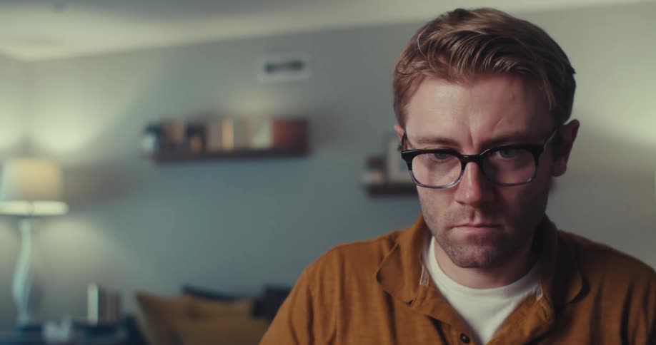 Close up of a man carefully stacking and arranging a set of playing cards in a room