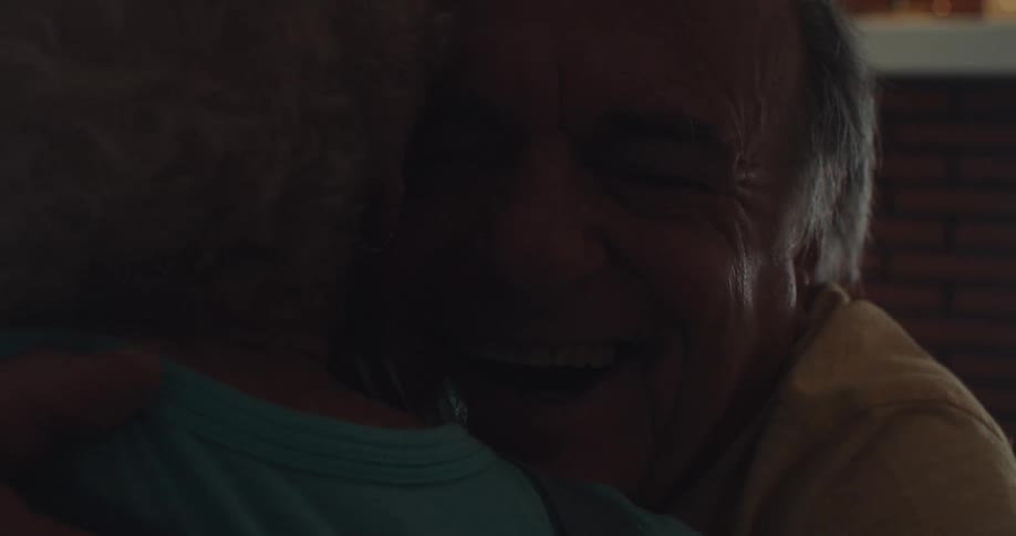 An elderly couple joyfully embraces each other with pure excitement and happiness