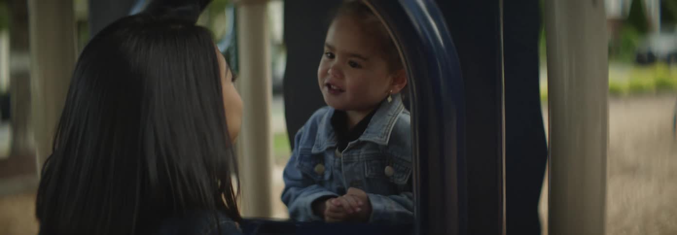 A mother and daughter are talking in the playground