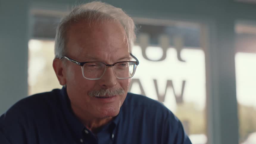 An elderly man talks