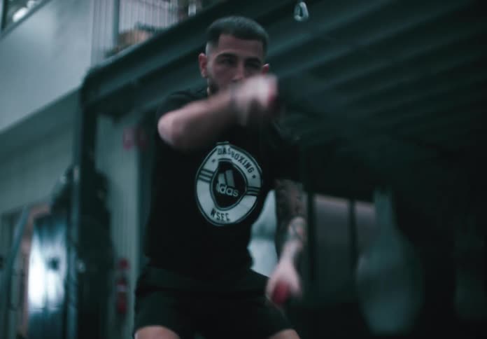 A person is training with battle ropes in a dimly lit gym