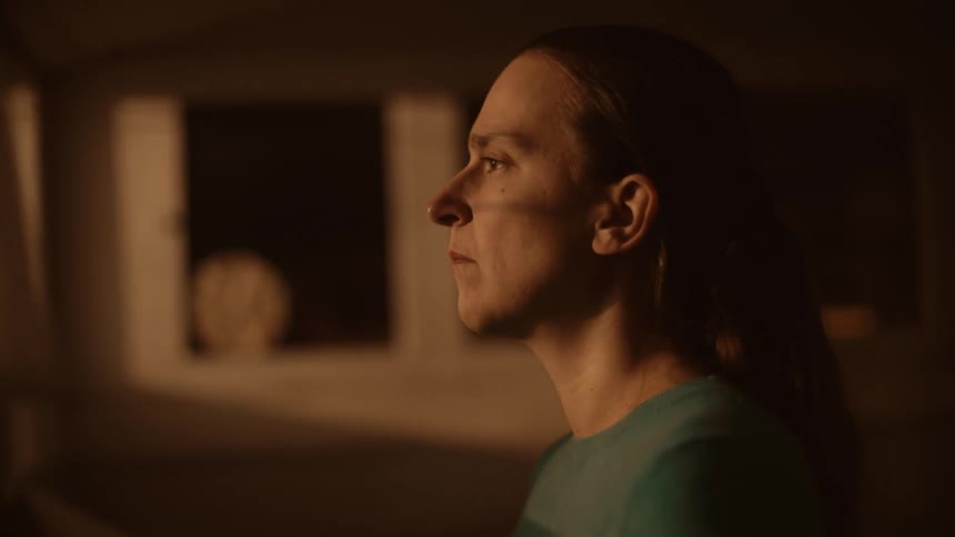 A woman walks up to the window