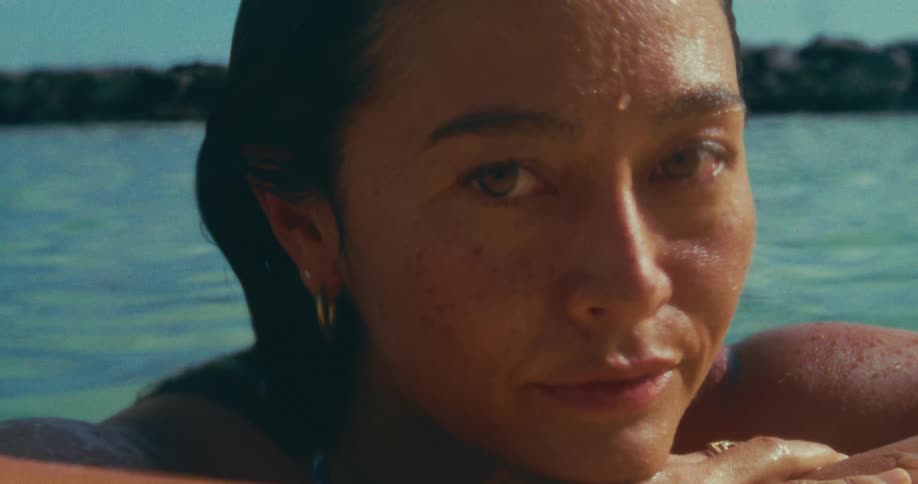 A woman is smiling in the water