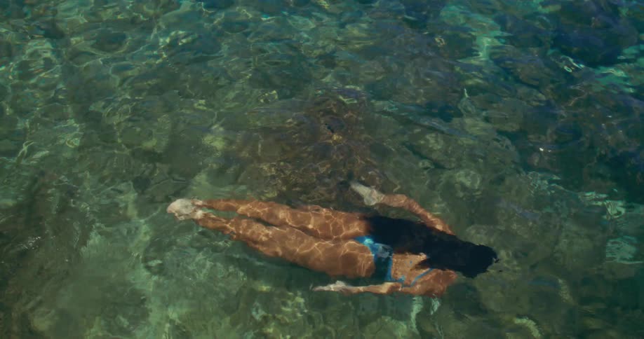 A person is snorkeling in clear tropical water
