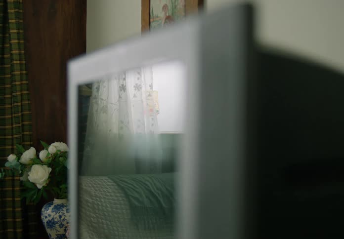 A television is turned off in a living room of a house