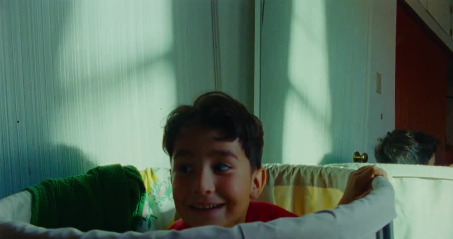 A boy playing hide and seek in a bedroom