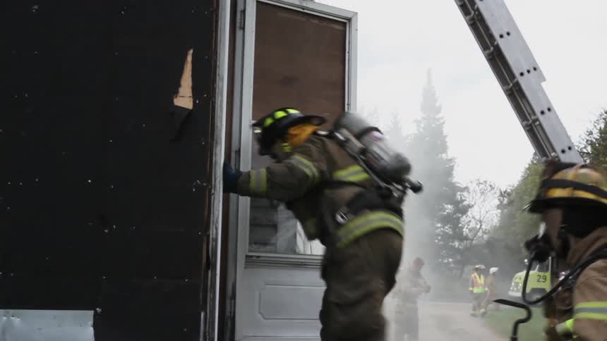 Firemen move into a smokey home
