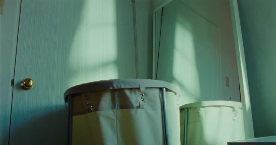 A child is playing hide and seek by the mirror
