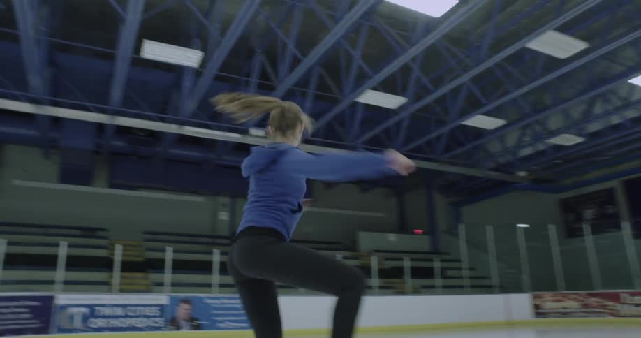 A figure skater spins on the ice