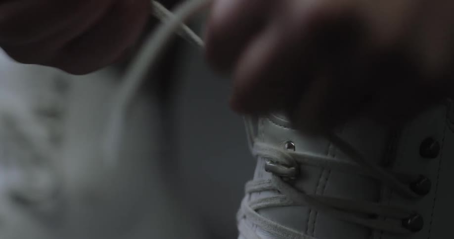 A woman laces up and ties a skate