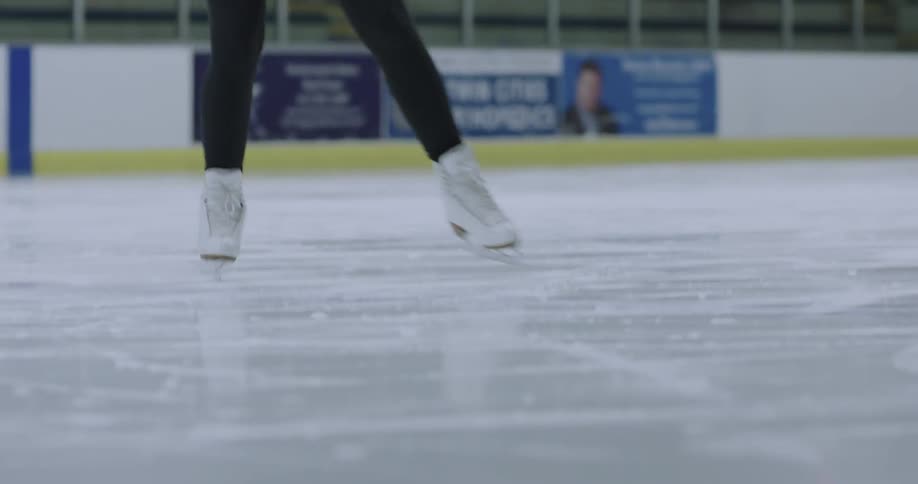 A figure skater practices on the ice