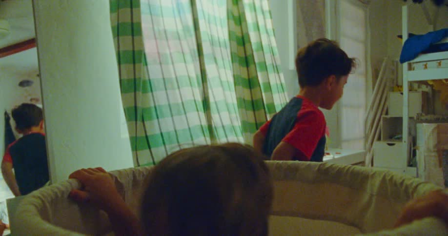 A couple of kids play hide and seek with excitement inside a room