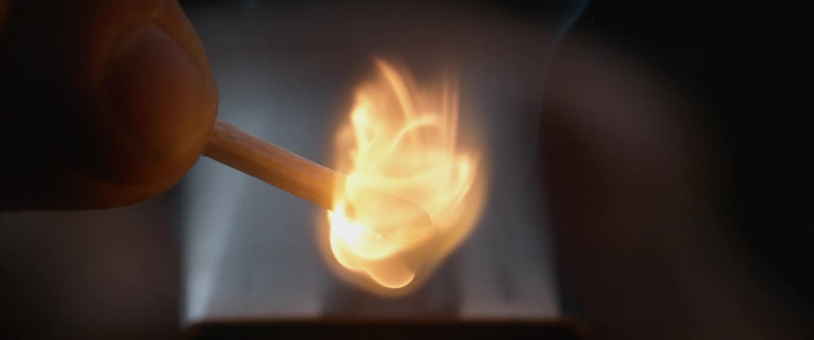 A match is lit and burns in slow motion