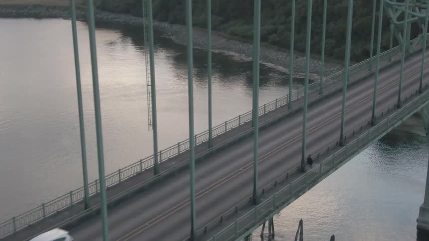 Cars drive over the long bridge