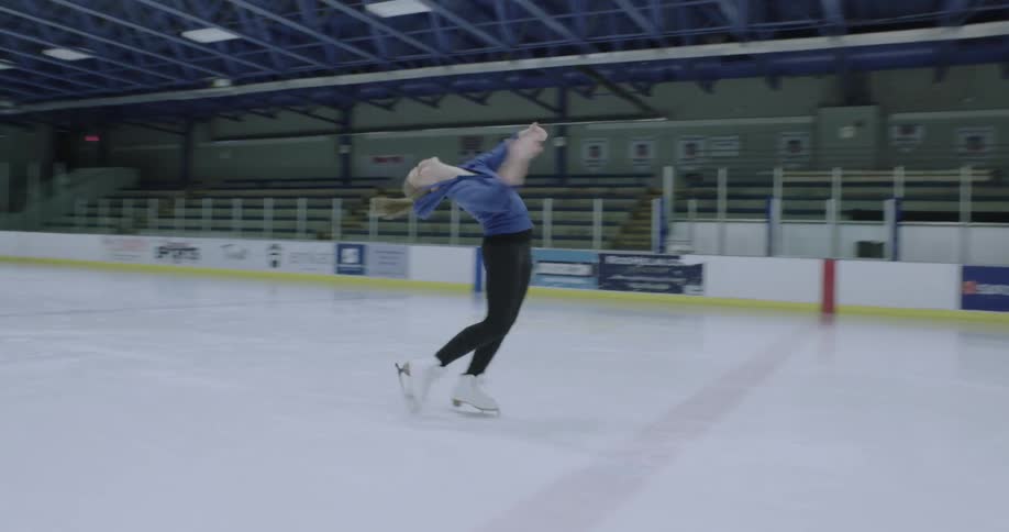A woman is doing twirls on ice skates