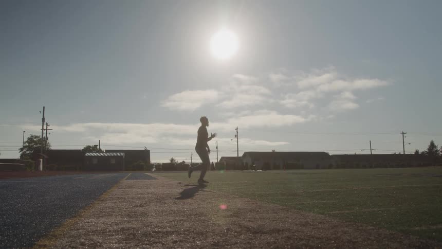 Man on a sports field warming up
