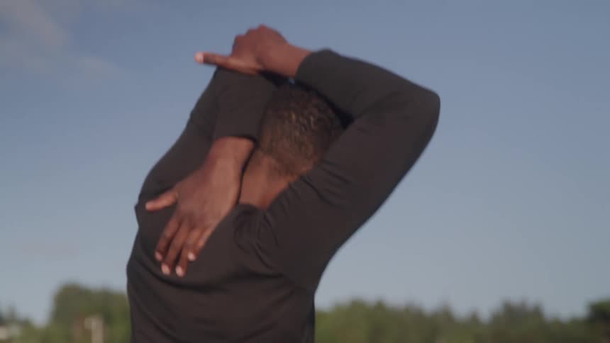 Man walking and stretching his arms