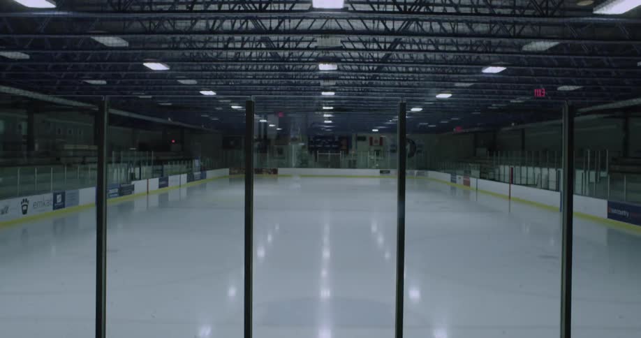 The lights of an indoor ice skating rink are turned on
