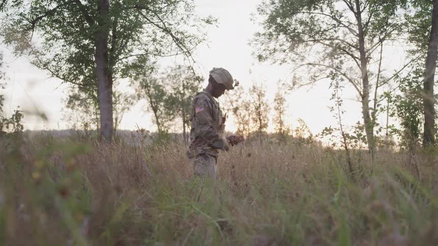 Military man in uniform in a forest