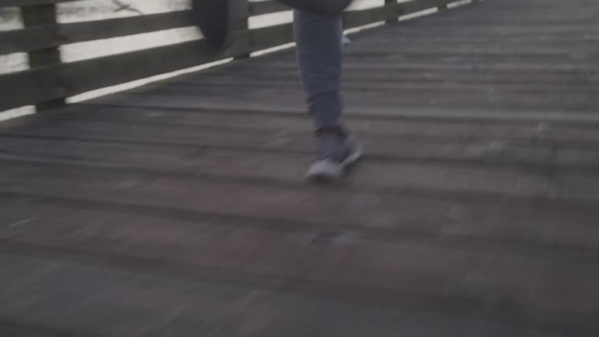 A person runs down a boardwalk