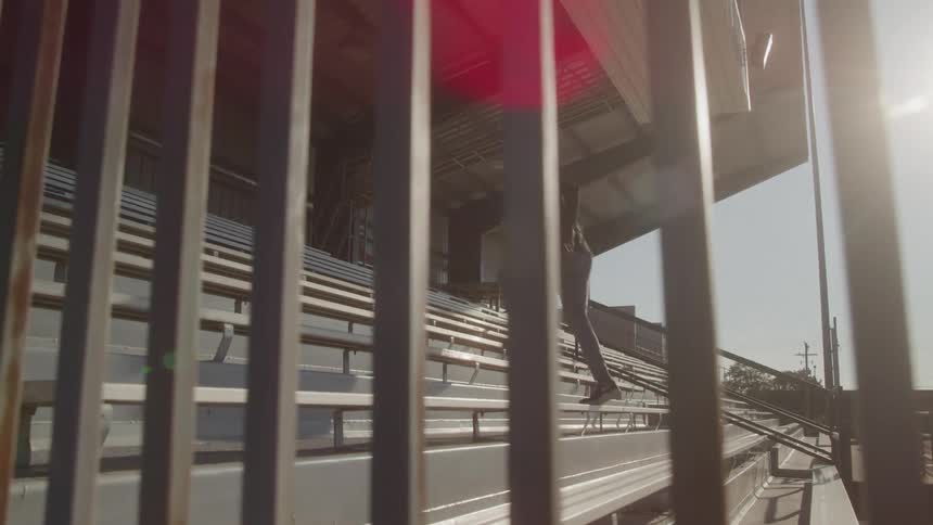 Man running up the stairs of a grandstand