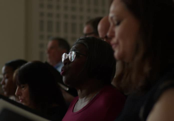 A woman singing in a choir