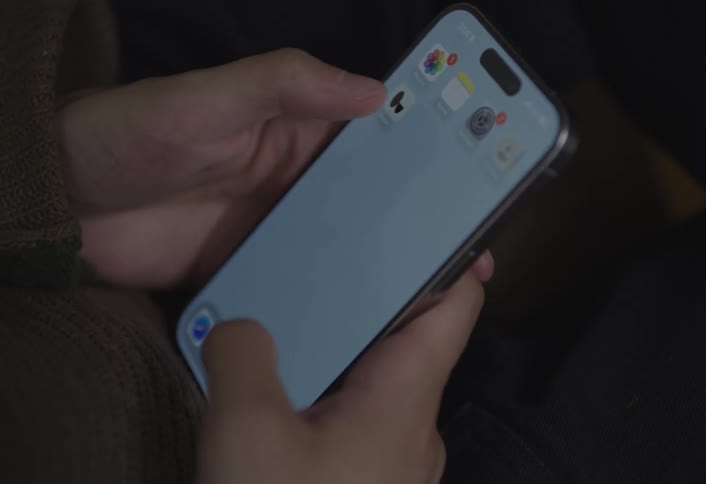 Pair of hands unlocking a smartphone and accessing an app