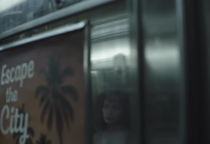 A woman sitting inside public transport